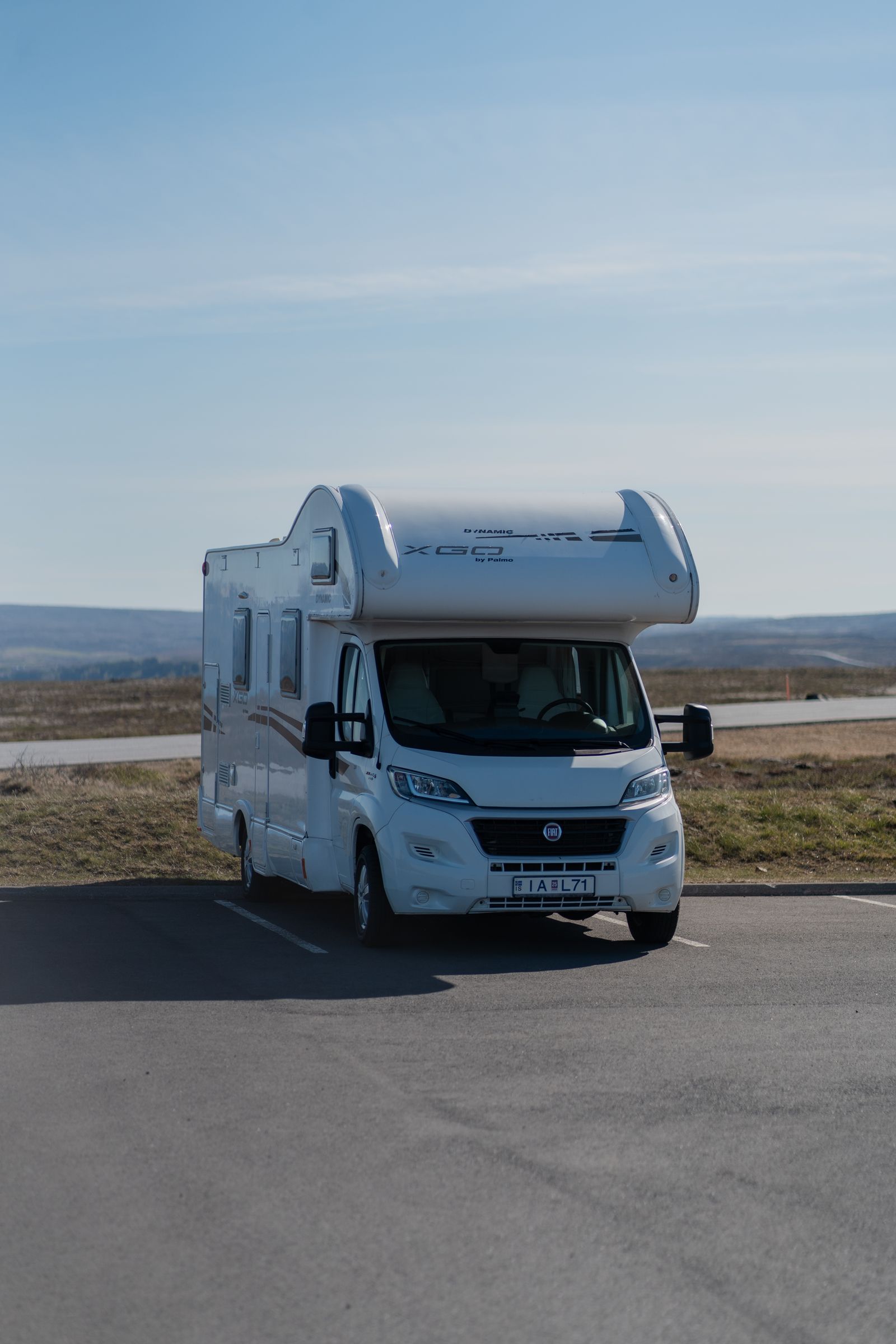 White Class C motorhome parked on open highway